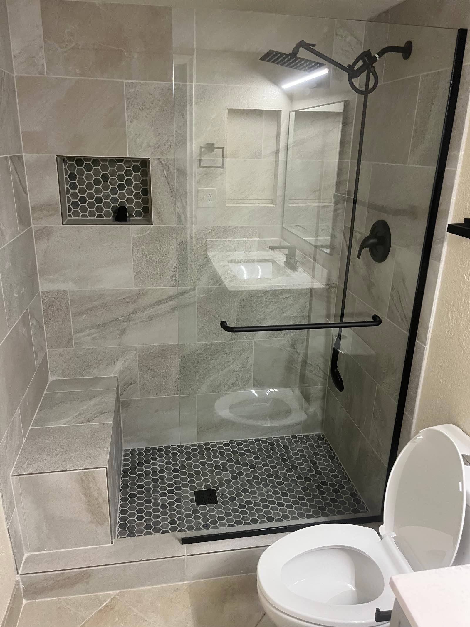 Custom tile shower remodel with frameless glass